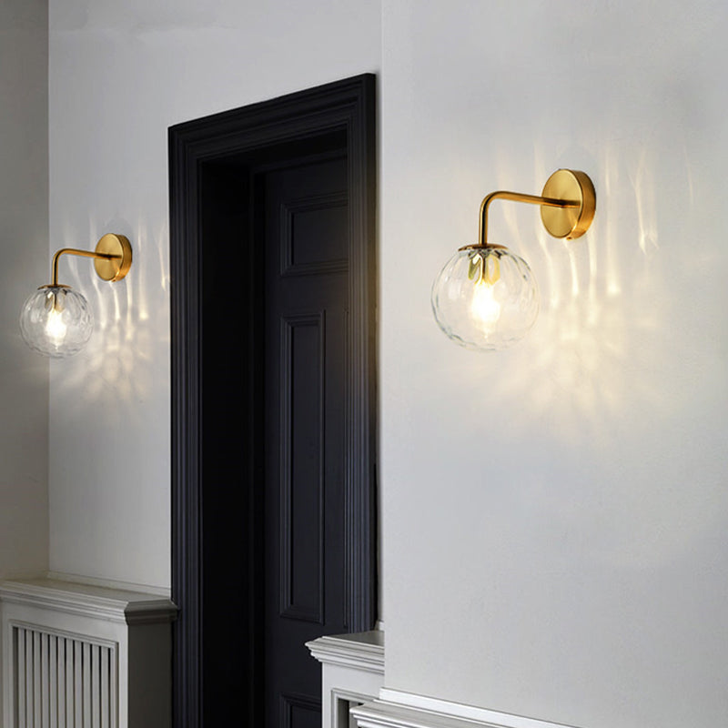 Ball Shaped Wall Lamp Minimalist Clear Rippling Glass 1-Light Bedroom Wall Mounted Lighting with Bent Arm in Black/Gold Clearhalo 'Cast Iron' 'Glass' 'Industrial' 'Modern wall lights' 'Modern' 'Tiffany' 'Traditional wall lights' 'Wall Lamps & Sconces' 'Wall Lights' Lighting' 1936628