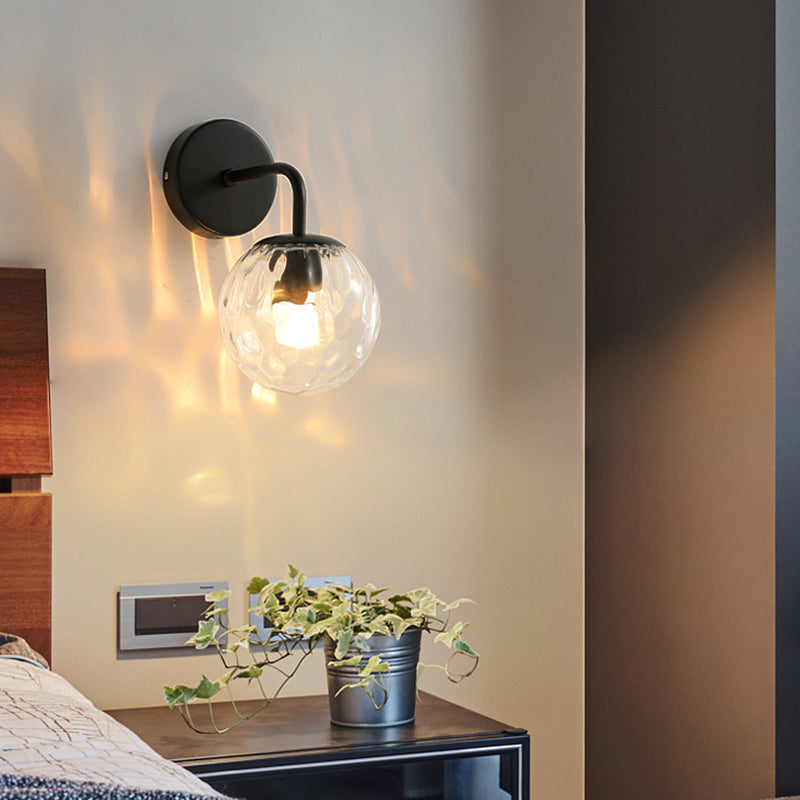 Ball Shaped Wall Lamp Minimalist Clear Rippling Glass 1-Light Bedroom Wall Mounted Lighting with Bent Arm in Black/Gold Black Clearhalo 'Cast Iron' 'Glass' 'Industrial' 'Modern wall lights' 'Modern' 'Tiffany' 'Traditional wall lights' 'Wall Lamps & Sconces' 'Wall Lights' Lighting' 1936631