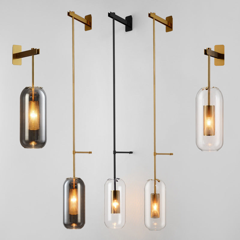 Postmodern Capsule Wall Hanging Light Clear Glass 1 Bulb Bedside Wall Mounted Lamp with Interior Mesh Guard in Black/Gold Clearhalo 'Cast Iron' 'Glass' 'Industrial' 'Modern wall lights' 'Modern' 'Tiffany' 'Traditional wall lights' 'Wall Lamps & Sconces' 'Wall Lights' Lighting' 1936748