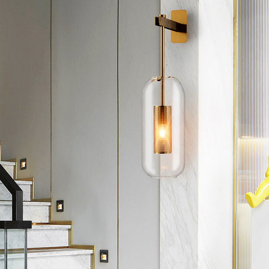 Postmodern Capsule Wall Hanging Light Clear Glass 1 Bulb Bedside Wall Mounted Lamp with Interior Mesh Guard in Black/Gold Gold Clearhalo 'Cast Iron' 'Glass' 'Industrial' 'Modern wall lights' 'Modern' 'Tiffany' 'Traditional wall lights' 'Wall Lamps & Sconces' 'Wall Lights' Lighting' 1936749