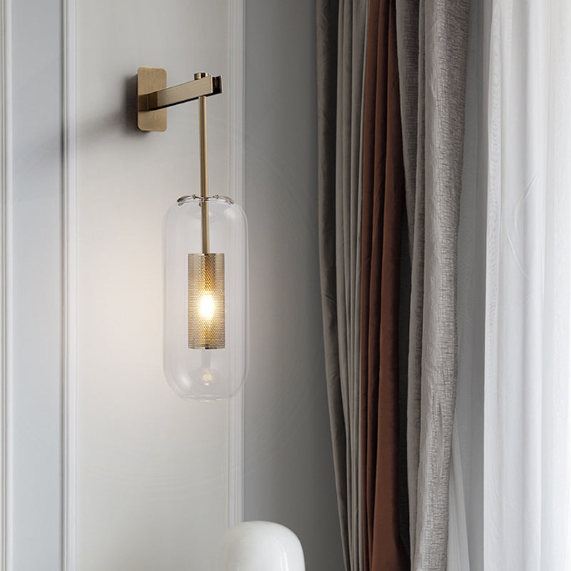 Postmodern Capsule Wall Hanging Light Clear Glass 1 Bulb Bedside Wall Mounted Lamp with Interior Mesh Guard in Black/Gold Clearhalo 'Cast Iron' 'Glass' 'Industrial' 'Modern wall lights' 'Modern' 'Tiffany' 'Traditional wall lights' 'Wall Lamps & Sconces' 'Wall Lights' Lighting' 1936750