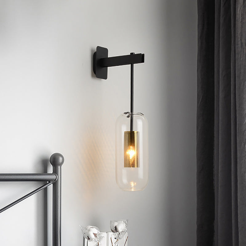 Postmodern Capsule Wall Hanging Light Clear Glass 1 Bulb Bedside Wall Mounted Lamp with Interior Mesh Guard in Black/Gold Black Clearhalo 'Cast Iron' 'Glass' 'Industrial' 'Modern wall lights' 'Modern' 'Tiffany' 'Traditional wall lights' 'Wall Lamps & Sconces' 'Wall Lights' Lighting' 1936754