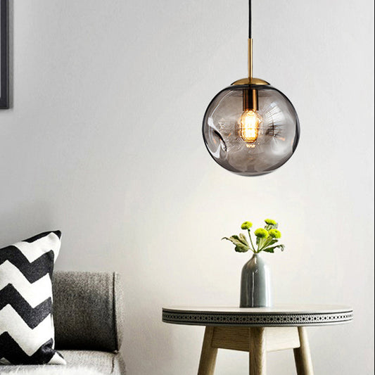 Dimpled Sphere Ceiling Pendant Modern Cognac/Smoke Grey Glass 1 Head Brass Hanging Light Fixture for Living Room Smoke Gray Clearhalo 'Ceiling Lights' 'Glass shade' 'Glass' 'Modern Pendants' 'Modern' 'Pendant Lights' 'Pendants' Lighting' 1937203
