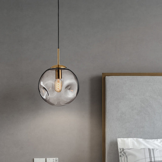 Dimpled Sphere Ceiling Pendant Modern Cognac/Smoke Grey Glass 1 Head Brass Hanging Light Fixture for Living Room Clearhalo 'Ceiling Lights' 'Glass shade' 'Glass' 'Modern Pendants' 'Modern' 'Pendant Lights' 'Pendants' Lighting' 1937204