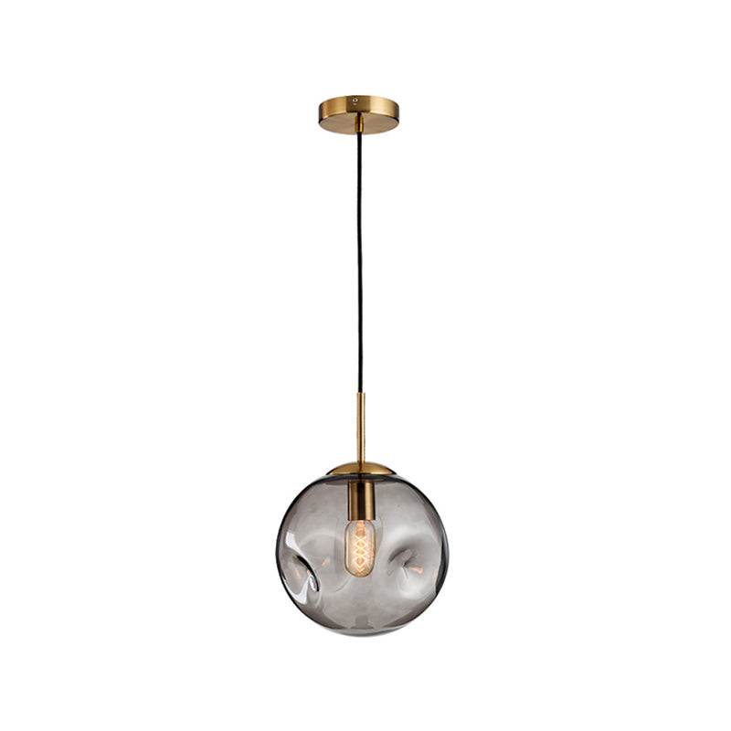 Dimpled Sphere Ceiling Pendant Modern Cognac/Smoke Grey Glass 1 Head Brass Hanging Light Fixture for Living Room Clearhalo 'Ceiling Lights' 'Glass shade' 'Glass' 'Modern Pendants' 'Modern' 'Pendant Lights' 'Pendants' Lighting' 1937205