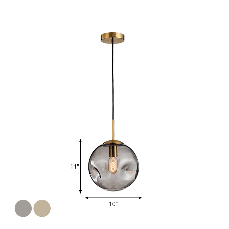 Dimpled Sphere Ceiling Pendant Modern Cognac/Smoke Grey Glass 1 Head Brass Hanging Light Fixture for Living Room Clearhalo 'Ceiling Lights' 'Glass shade' 'Glass' 'Modern Pendants' 'Modern' 'Pendant Lights' 'Pendants' Lighting' 1937206