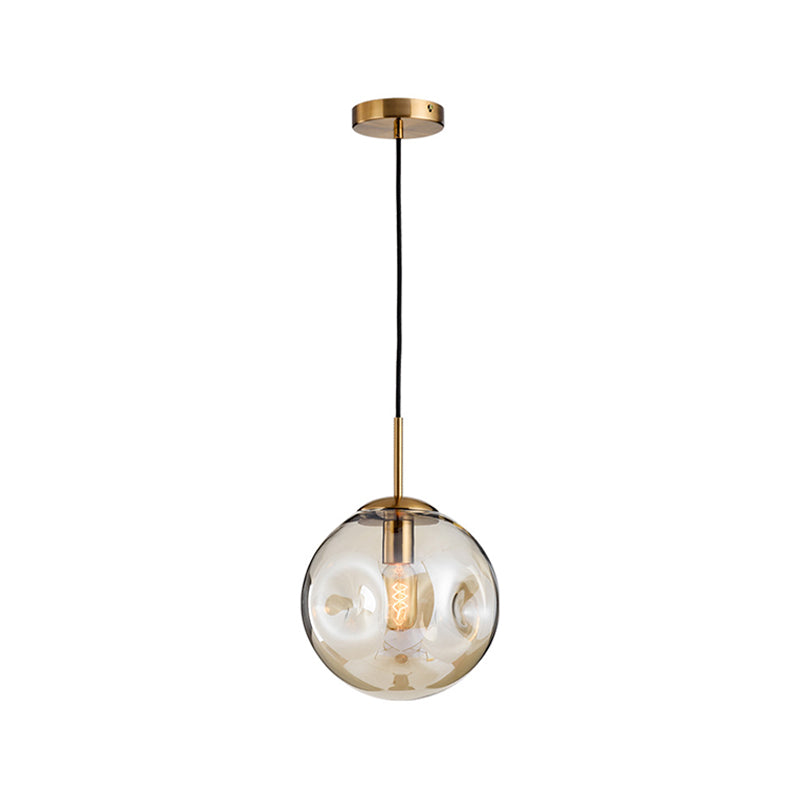 Dimpled Sphere Ceiling Pendant Modern Cognac/Smoke Grey Glass 1 Head Brass Hanging Light Fixture for Living Room Clearhalo 'Ceiling Lights' 'Glass shade' 'Glass' 'Modern Pendants' 'Modern' 'Pendant Lights' 'Pendants' Lighting' 1937209