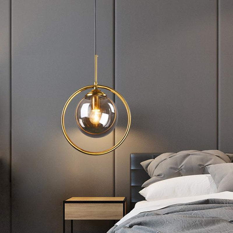 Globe Down Lighting Pendant Postmodern Clear/Amber/Smoke Grey Glass Single-Bulb Bedroom Suspension Light with Brass Ring Smoke Gray Clearhalo 'Ceiling Lights' 'Glass shade' 'Glass' 'Modern Pendants' 'Modern' 'Pendant Lights' 'Pendants' Lighting' 1937397