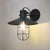 1-Light Conic Adjustable Wall Light Industrial Black Iron Sconce Lamp with Capsule Cage and Clear Glass Shade Black Clearhalo 'Art deco wall lights' 'Cast Iron' 'Glass' 'Industrial wall lights' 'Industrial' 'Middle century wall lights' 'Modern' 'Rustic wall lights' 'Tiffany' 'Traditional wall lights' 'Wall Lamps & Sconces' 'Wall Lights' Lighting' 1969655