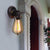 1 Bulb Adjustable Wall Lighting Ideas Loft Style Bedroom Wall Lamp with Pear Iron Cage in Black Black Clearhalo 'Art deco wall lights' 'Cast Iron' 'Glass' 'Industrial wall lights' 'Industrial' 'Middle century wall lights' 'Modern' 'Rustic wall lights' 'Tiffany' 'Traditional wall lights' 'Wall Lamps & Sconces' 'Wall Lights' Lighting' 1971194-sw