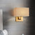Postmodern Cuboid Sconce Lamp Fabric 1-Light Bedside Reading Wall Light in White/Beige/Brown with Black/Gold Arm Gold Brown Clearhalo 'Cast Iron' 'Glass' 'Industrial' 'Modern wall lights' 'Modern' 'Tiffany' 'Traditional wall lights' 'Wall Lamps & Sconces' 'Wall Lights' Lighting' 1982889