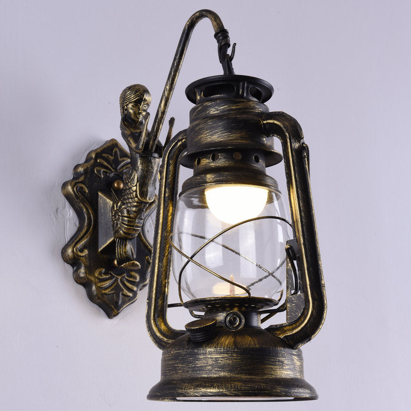 Clear Glass Kerosene Wall Light Fixture Nautical 1 Head Restaurant Wall Sconce with Curved Arm Brass A Clearhalo 'Art deco wall lights' 'Cast Iron' 'Glass' 'Industrial wall lights' 'Industrial' 'Middle century wall lights' 'Modern' 'Rustic wall lights' 'Tiffany' 'Traditional wall lights' 'Wall Lamps & Sconces' 'Wall Lights' Lighting' 2011502