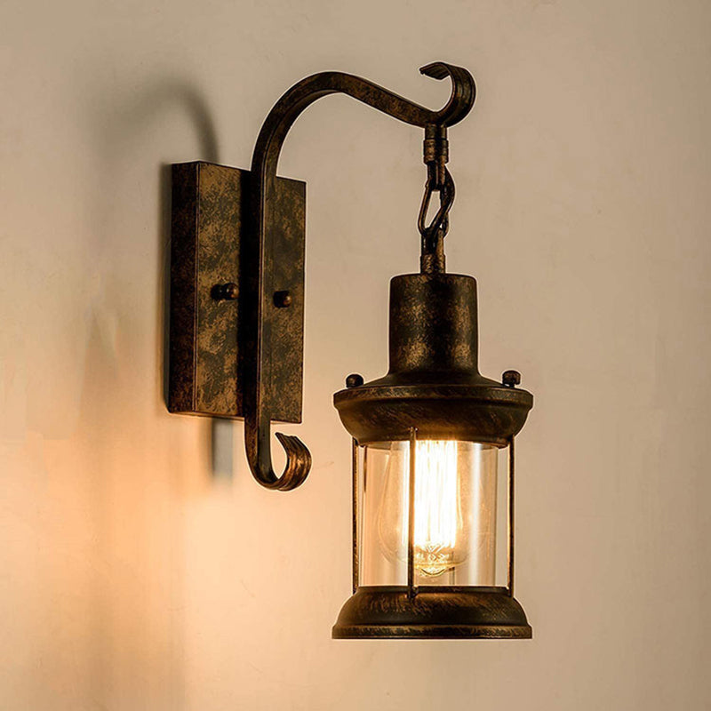 Lantern Wall Mount Light Fixture Coastal Clear Glass 1-Light Dining Room Wall Sconce Lighting with Curved Arm Bronze Clearhalo 'Art deco wall lights' 'Cast Iron' 'Glass' 'Industrial wall lights' 'Industrial' 'Middle century wall lights' 'Modern' 'Rustic wall lights' 'Tiffany' 'Traditional wall lights' 'Wall Lamps & Sconces' 'Wall Lights' Lighting' 2011532