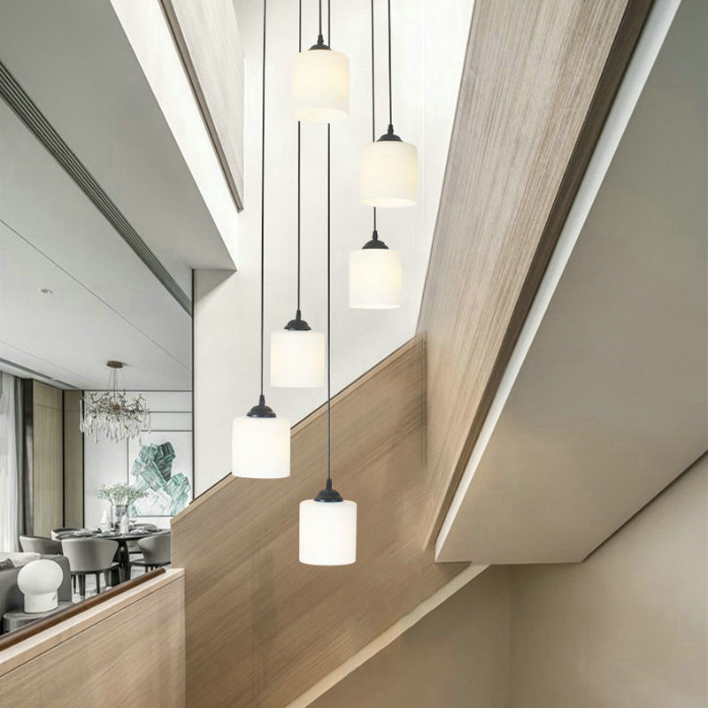 Modernism Cylinder Cluster Pendant Opal Glass Stairs Pendulum Light in Black with Round Canopy 6 White A Clearhalo 'Ceiling Lights' 'Modern Pendants' 'Modern' 'Pendant Lights' 'Pendants' Lighting' 2025668