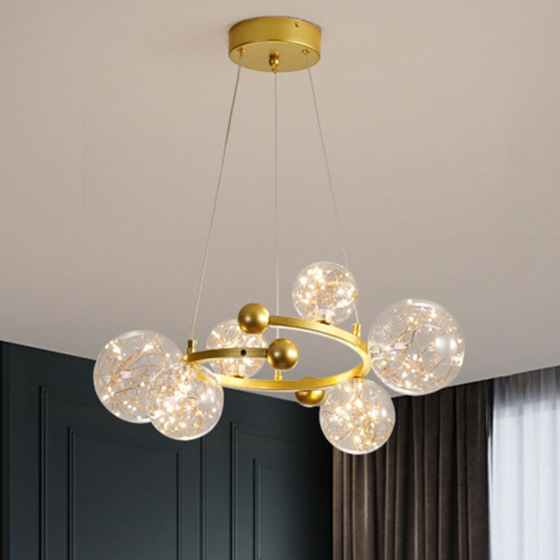 Clear Glass Orb Chandelier Lamp Contemporary LED Down Lighting with Glowing String 6 Gold Clearhalo 'Ceiling Lights' 'Chandeliers' 'Glass shade' 'Glass' 'Modern Chandeliers' 'Modern' Lighting' 2025913