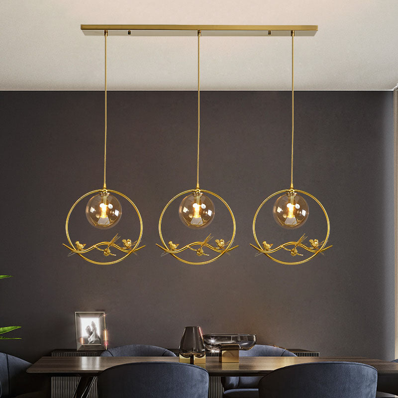 Globe Bedroom Pendant Light Vintage Smoke Gray/Clear/Amber Glass 1/3 Lights Brass Hanging Light with Round/Linear Canopy 3 Amber Linear Clearhalo 'Ceiling Lights' 'Chandeliers' 'Glass shade' 'Glass' 'Pendant Lights' 'Pendants' Lighting' 203581
