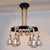 Globe Metal and Rope Chandelier Lighting Rustic 6/8 Light Dining Room Pendant Lighting in Black with Ring 6 Black Clearhalo 'Cast Iron' 'Ceiling Lights' 'Chandeliers' 'Industrial Chandeliers' 'Industrial' 'Metal' 'Middle Century Chandeliers' 'Rustic Chandeliers' 'Tiffany' Lighting' 210032