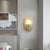 Oval Shaped Metallic Wall Light Fixture Postmodern Style 1-Light Brass Wall Mounted Lamp Brass Clearhalo 'Cast Iron' 'Glass' 'Industrial' 'Modern wall lights' 'Modern' 'Tiffany' 'Traditional wall lights' 'Wall Lamps & Sconces' 'Wall Lights' Lighting' 2121438