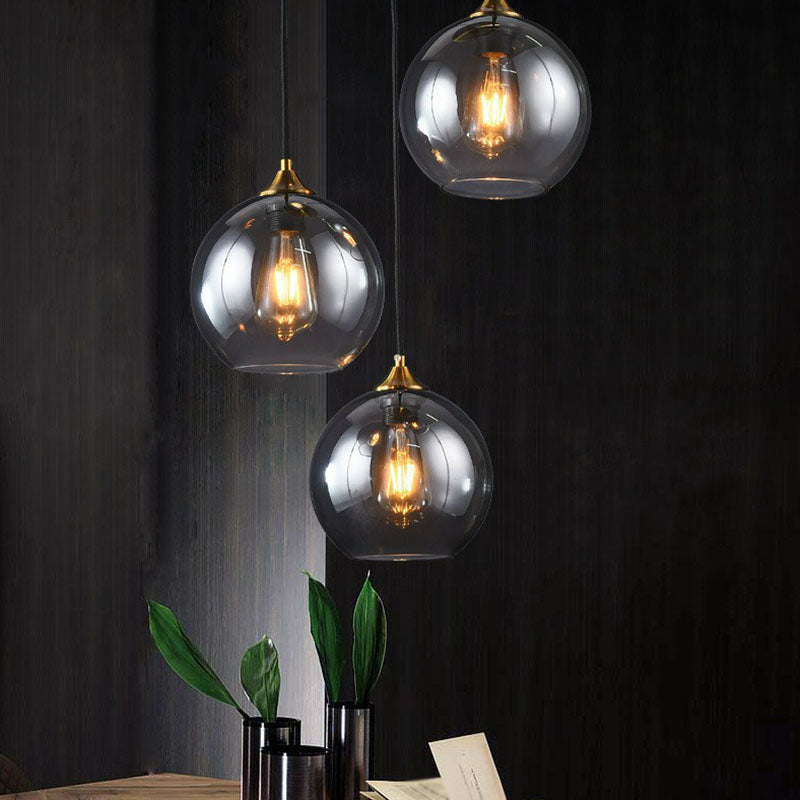 Postmodern 3-Light Pendant Antiqued Brass Globe Multiple Hanging Lamp with Glass Shade Clearhalo 'Ceiling Lights' 'Modern Pendants' 'Modern' 'Pendant Lights' 'Pendants' Lighting' 2266031