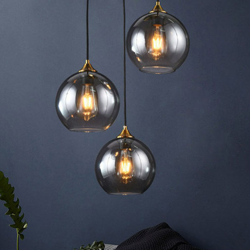 Postmodern 3-Light Pendant Antiqued Brass Globe Multiple Hanging Lamp with Glass Shade Smoke Gray Round Clearhalo 'Ceiling Lights' 'Modern Pendants' 'Modern' 'Pendant Lights' 'Pendants' Lighting' 2266032