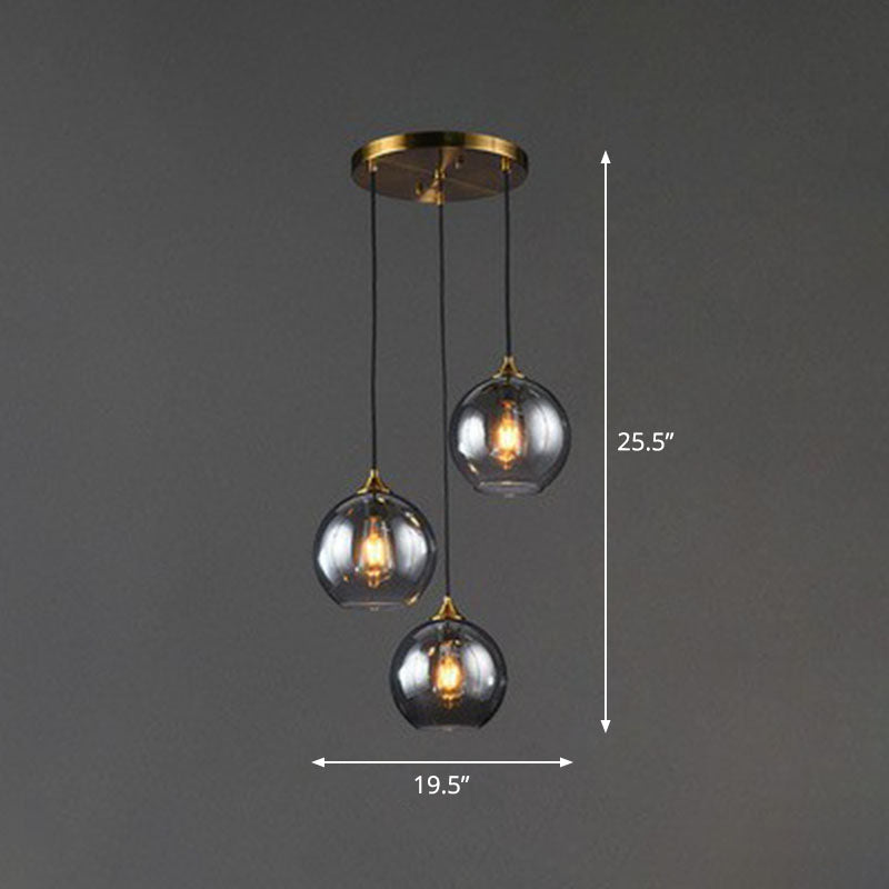 Postmodern 3-Light Pendant Antiqued Brass Globe Multiple Hanging Lamp with Glass Shade Clearhalo 'Ceiling Lights' 'Modern Pendants' 'Modern' 'Pendant Lights' 'Pendants' Lighting' 2266033