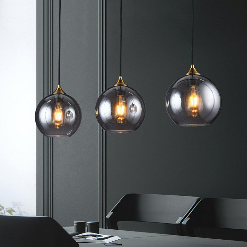 Postmodern 3-Light Pendant Antiqued Brass Globe Multiple Hanging Lamp with Glass Shade Smoke Gray Linear Clearhalo 'Ceiling Lights' 'Modern Pendants' 'Modern' 'Pendant Lights' 'Pendants' Lighting' 2266034