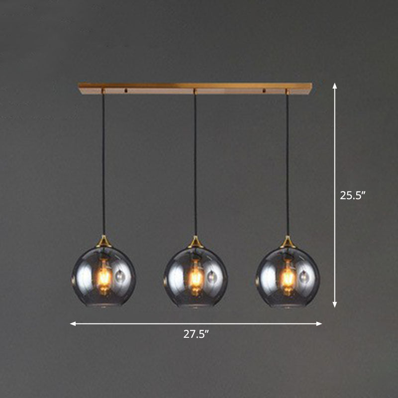 Postmodern 3-Light Pendant Antiqued Brass Globe Multiple Hanging Lamp with Glass Shade Clearhalo 'Ceiling Lights' 'Modern Pendants' 'Modern' 'Pendant Lights' 'Pendants' Lighting' 2266035