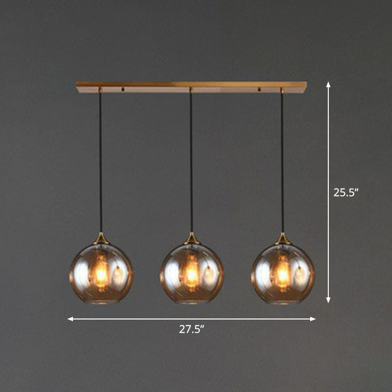 Postmodern 3-Light Pendant Antiqued Brass Globe Multiple Hanging Lamp with Glass Shade Clearhalo 'Ceiling Lights' 'Modern Pendants' 'Modern' 'Pendant Lights' 'Pendants' Lighting' 2266037