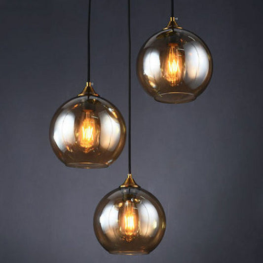 Postmodern 3-Light Pendant Antiqued Brass Globe Multiple Hanging Lamp with Glass Shade Amber Round Clearhalo 'Ceiling Lights' 'Modern Pendants' 'Modern' 'Pendant Lights' 'Pendants' Lighting' 2266038