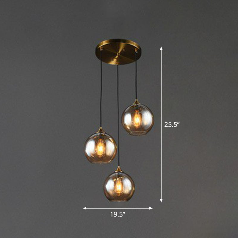 Postmodern 3-Light Pendant Antiqued Brass Globe Multiple Hanging Lamp with Glass Shade Clearhalo 'Ceiling Lights' 'Modern Pendants' 'Modern' 'Pendant Lights' 'Pendants' Lighting' 2266039