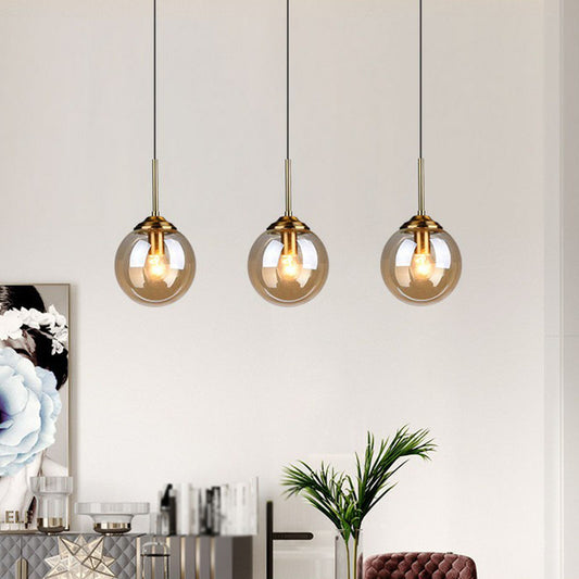 Minimalistic Spherical Multi Ceiling Light Glass 3-Bulb Dining Room Suspension Pendant in Brass Amber Clearhalo 'Ceiling Lights' 'Modern Pendants' 'Modern' 'Pendant Lights' 'Pendants' Lighting' 2266041