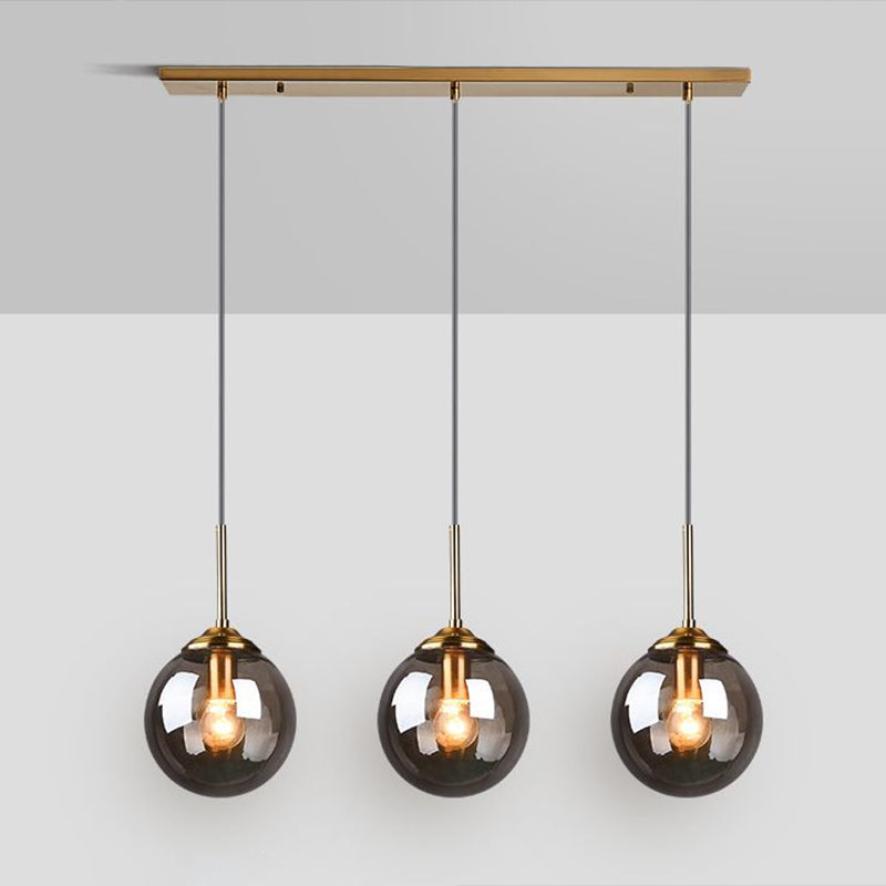 Minimalistic Spherical Multi Ceiling Light Glass 3-Bulb Dining Room Suspension Pendant in Brass Clearhalo 'Ceiling Lights' 'Modern Pendants' 'Modern' 'Pendant Lights' 'Pendants' Lighting' 2266044