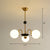 Ivory Glass Ball Chandelier Postmodern Black and Brass Hanging Lighting for Dining Room 3 Gold Clearhalo 'Ceiling Lights' 'Chandeliers' 'Modern Chandeliers' 'Modern' Lighting' 2269101