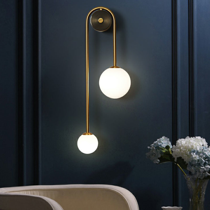 Brass Arc Wall Lighting Postmodern 2-Head Metal Sconce Light with Ball Opal Glass Shade Clearhalo 'Cast Iron' 'Glass' 'Industrial' 'Modern wall lights' 'Modern' 'Tiffany' 'Traditional wall lights' 'Wall Lamps & Sconces' 'Wall Lights' Lighting' 2353448
