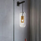 Pill Capsule Clear Glass Wall Sconce Postmodern 1-Light Wall Hanging Light with Mesh Cage Clearhalo 'Cast Iron' 'Glass' 'Industrial' 'Modern wall lights' 'Modern' 'Tiffany' 'Traditional wall lights' 'Wall Lamps & Sconces' 'Wall Lights' Lighting' 2353470