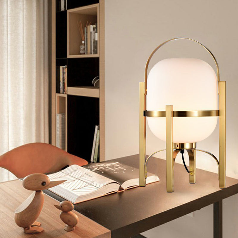 Capsule Glass Night Lamp Postmodern 1-Light Brass Finish Table Light with Quadpod and Arched Handle Clearhalo 'Lamps' 'Table Lamps' Lighting' 2353526