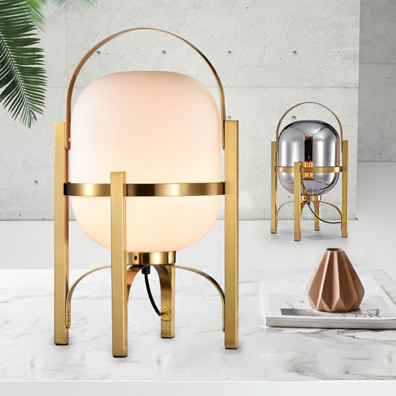 Capsule Glass Night Lamp Postmodern 1-Light Brass Finish Table Light with Quadpod and Arched Handle Clearhalo 'Lamps' 'Table Lamps' Lighting' 2353528