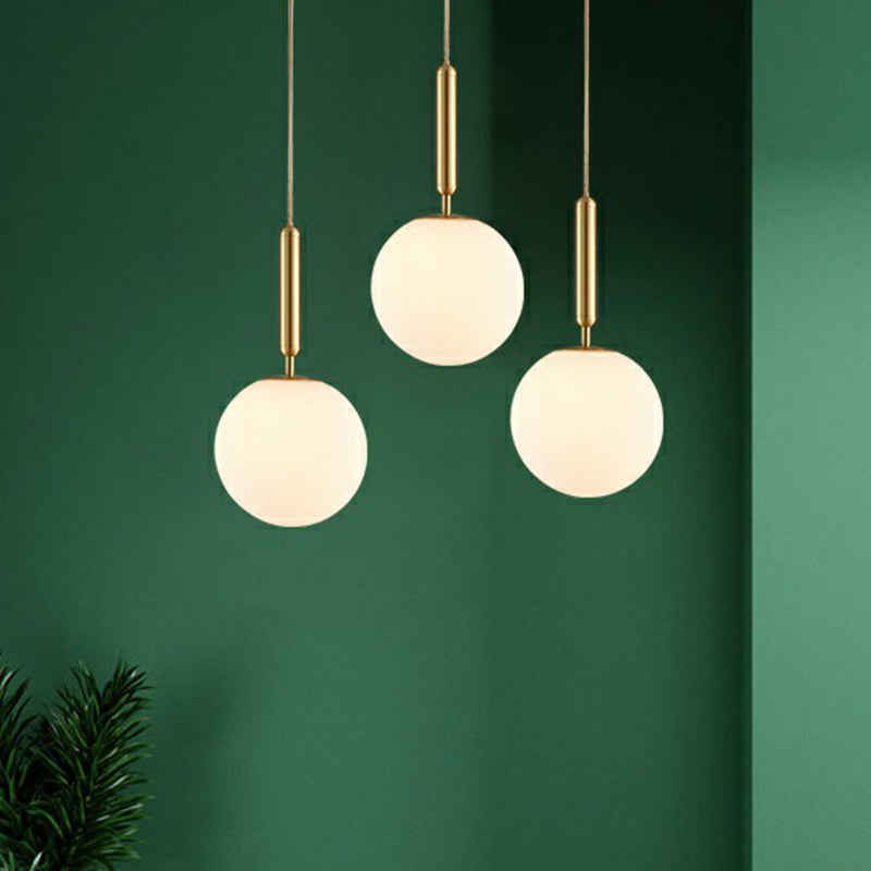Ball Dining Room Pendulum Light White Glass 1-Head Simple Pendant Lighting in Brass Clearhalo 'Ceiling Lights' 'Modern Pendants' 'Modern' 'Pendant Lights' 'Pendants' Lighting' 2353832