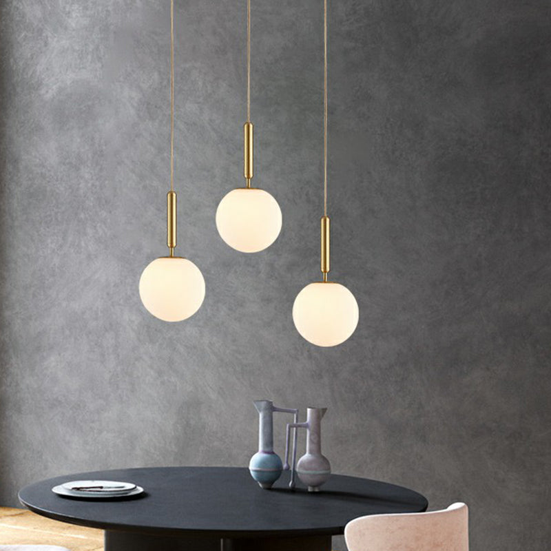 Ball Dining Room Pendulum Light White Glass 1-Head Simple Pendant Lighting in Brass Clearhalo 'Ceiling Lights' 'Modern Pendants' 'Modern' 'Pendant Lights' 'Pendants' Lighting' 2353838