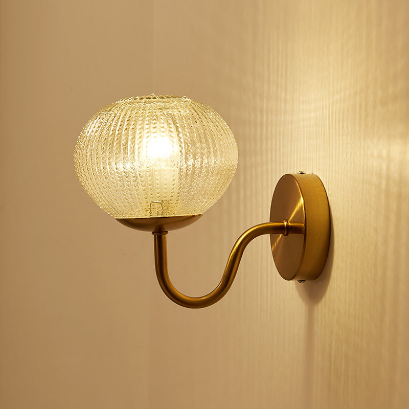 Postmodern Ball Shaped Sconce Lamp Textured Glass 1-Bulb Bedside Wall Light in Brass Clearhalo 'Cast Iron' 'Glass' 'Industrial' 'Modern wall lights' 'Modern' 'Tiffany' 'Traditional wall lights' 'Wall Lamps & Sconces' 'Wall Lights' Lighting' 2356715