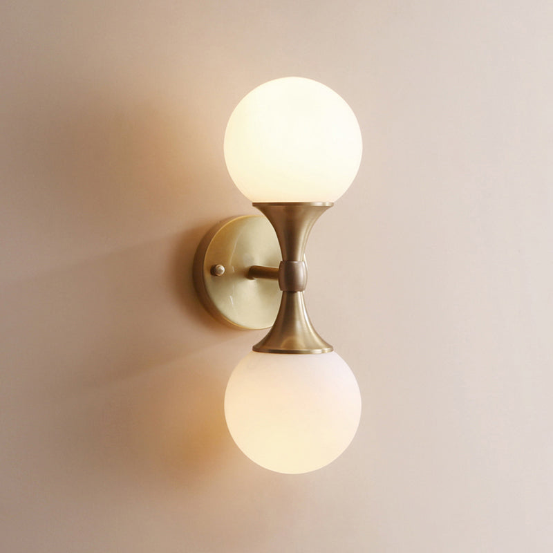 Simple Style Ball Wall Lamp Ivory Glass 2-Head Bedroom Wall Sconce Light in Brass Clearhalo 'Cast Iron' 'Glass' 'Industrial' 'Modern wall lights' 'Modern' 'Tiffany' 'Traditional wall lights' 'Wall Lamps & Sconces' 'Wall Lights' Lighting' 2356747