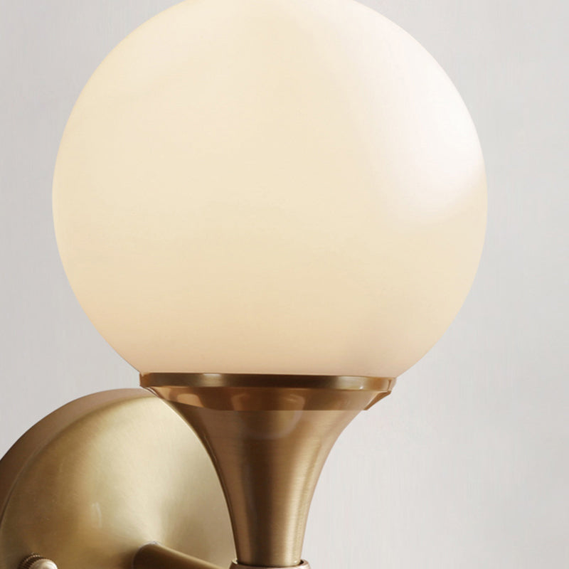 Simple Style Ball Wall Lamp Ivory Glass 2-Head Bedroom Wall Sconce Light in Brass Clearhalo 'Cast Iron' 'Glass' 'Industrial' 'Modern wall lights' 'Modern' 'Tiffany' 'Traditional wall lights' 'Wall Lamps & Sconces' 'Wall Lights' Lighting' 2356748