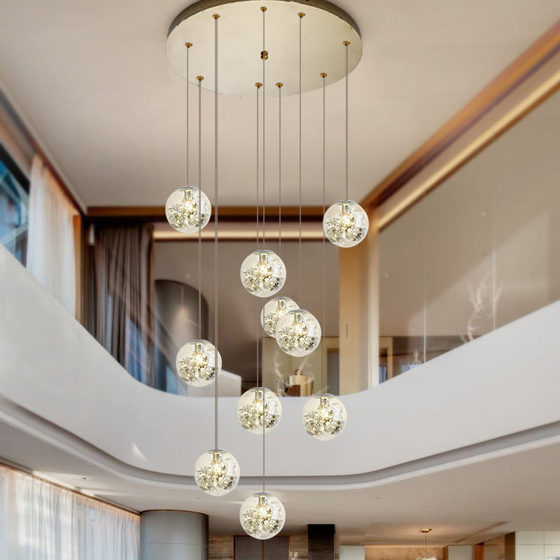 Minimalist Sphere Multi Light Chandelier Clear Glass 10-Head Stairs Pendant Lamp with Metal Flower Decor in Gold Gold Clearhalo 'Ceiling Lights' 'Close To Ceiling Lights' 'Glass shade' 'Glass' 'Modern Pendants' 'Modern' 'Pendant Lights' 'Pendants' Lighting' 2384717