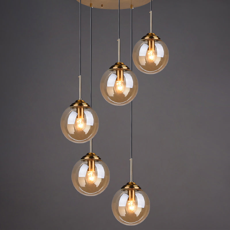 Brass Finish Cluster Ball Pendant Post-Modern 5 Bulbs Glass Suspended Lighting Fixture Amber Globe Clearhalo 'Ceiling Lights' 'Modern Pendants' 'Modern' 'Pendant Lights' 'Pendants' Lighting' 2384747