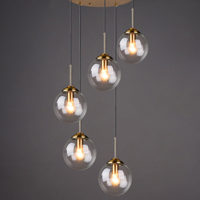Brass Finish Cluster Ball Pendant Post-Modern 5 Bulbs Glass Suspended Lighting Fixture Clear Globe Clearhalo 'Ceiling Lights' 'Modern Pendants' 'Modern' 'Pendant Lights' 'Pendants' Lighting' 2384749