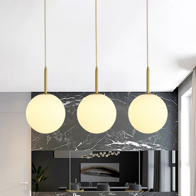 Sphere Opal Glass Multiple Lamp Pendant Minimalism 3-Bulb Gold Pendulum Light for Dining Room Clearhalo 'Ceiling Lights' 'Modern Pendants' 'Modern' 'Pendant Lights' 'Pendants' Lighting' 2423073