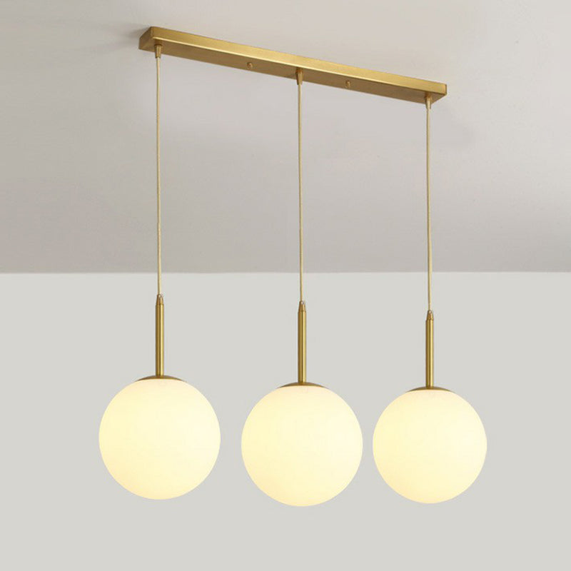 Sphere Opal Glass Multiple Lamp Pendant Minimalism 3-Bulb Gold Pendulum Light for Dining Room Gold 23.5" Clearhalo 'Ceiling Lights' 'Modern Pendants' 'Modern' 'Pendant Lights' 'Pendants' Lighting' 2423074