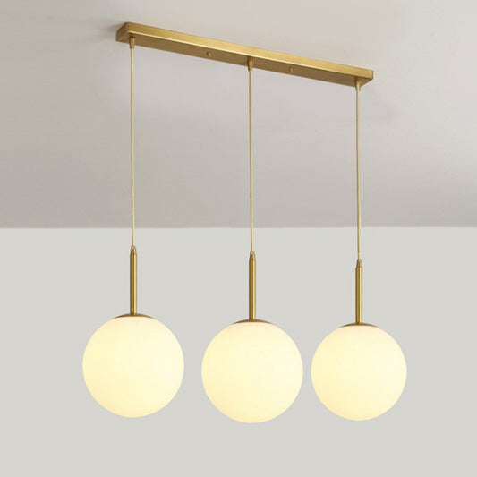 Sphere Opal Glass Multiple Lamp Pendant Minimalism 3-Bulb Gold Pendulum Light for Dining Room Gold 23.5" Clearhalo 'Ceiling Lights' 'Modern Pendants' 'Modern' 'Pendant Lights' 'Pendants' Lighting' 2423074