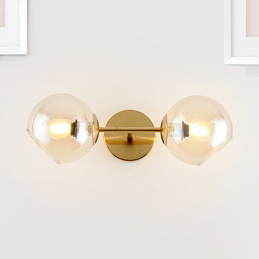 Modernist 2 Lights Wall Lamp with Clear Glass Shade Gold Spherical Wall Mount Light Fixture Gold Clearhalo 'Cast Iron' 'Glass' 'Industrial' 'Modern wall lights' 'Modern' 'Tiffany' 'Traditional wall lights' 'Wall Lamps & Sconces' 'Wall Lights' Lighting' 242547
