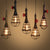 Single Bulb Shaped Cage Pendant Light Industrial Metal Suspension Light Fixture with Red Valve Deco Clearhalo 'Art Deco Pendants' 'Black' 'Cast Iron' 'Ceiling Lights' 'Ceramic' 'Crystal' 'Industrial Pendants' 'Industrial' 'Metal' 'Middle Century Pendants' 'Pendant Lights' 'Pendants' 'Rustic Pendants' 'Tiffany' Lighting' 2460902